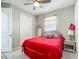 Cozy bedroom featuring a ceiling fan, a picture window, and wicker furniture at 591 Lake Smart Blvd, Winter Haven, FL 33881