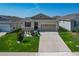 Beautiful single-story home offers a well-maintained lawn and driveway leading to a two-car garage at 591 Lake Smart Blvd, Winter Haven, FL 33881