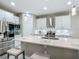 Bright kitchen with white cabinetry, stainless steel appliances, and a spacious island with bar stools at 591 Lake Smart Blvd, Winter Haven, FL 33881