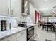 Contemporary kitchen boasts white cabinetry, quartz countertops, and stainless steel appliances at 591 Lake Smart Blvd, Winter Haven, FL 33881