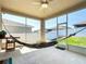 Screened lanai with ceiling fan and view of the fenced backyard at 591 Lake Smart Blvd, Winter Haven, FL 33881