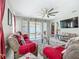 Cozy living room with comfortable seating, ceiling fan, and sliding glass doors to an outdoor hammock at 591 Lake Smart Blvd, Winter Haven, FL 33881