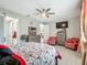 Well-lit main bedroom with a decorative bed, wooden dresser, and en-suite bathroom access at 591 Lake Smart Blvd, Winter Haven, FL 33881