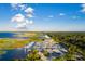 Aerial view showcasing the marina, waterfront, a restaurant, and parking with trees and sky in the backdrop at 621 Rebecca Dr, St Cloud, FL 34769
