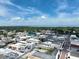 An aerial view shows city buildings, homes, and streets leading up to a large expanse of water under a blue sky at 621 Rebecca Dr, St Cloud, FL 34769