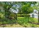 View of a backyard with green grass, trees, and a fence at 621 Rebecca Dr, St Cloud, FL 34769