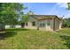 The backyard features mature trees, and a lush green lawn, perfect for outdoor activities and relaxation at 621 Rebecca Dr, St Cloud, FL 34769