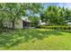 Well-manicured backyard featuring a screened patio, lush greenery, and a fenced perimeter at 621 Rebecca Dr, St Cloud, FL 34769