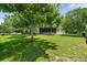 Landscaped backyard offering a private retreat with mature trees and a covered patio area at 621 Rebecca Dr, St Cloud, FL 34769