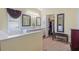 A well-lit bathroom features double sinks, a soaking tub, and a walk-in closet with a bench at 621 Rebecca Dr, St Cloud, FL 34769