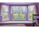 Close up of bedroom's window seat with decorative curtains and a view outside at 621 Rebecca Dr, St Cloud, FL 34769