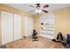 A simple bedroom includes 3 closets, a ceiling fan, and exercise equipment at 621 Rebecca Dr, St Cloud, FL 34769