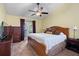 A spacious bedroom has a wooden bed, matching dresser, and French doors leading to the outside at 621 Rebecca Dr, St Cloud, FL 34769
