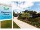 Outdoor sign for Cannery Park at entrance with playground in background and open from Dawn to Dusk at 621 Rebecca Dr, St Cloud, FL 34769
