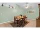 A cozy dining room features tile floors, a wooden table with four chairs, and overhead fan lighting at 621 Rebecca Dr, St Cloud, FL 34769