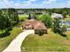 Charming home with manicured lawn, mature landscaping, and a curved driveway leading to the front door at 621 Rebecca Dr, St Cloud, FL 34769