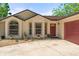 Inviting exterior showcasing a manicured front yard and charming architectural details at 621 Rebecca Dr, St Cloud, FL 34769