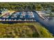 Aerial shot of the marina featuring a long dock, numerous boats, and a boat launch for endless aquatic adventures at 621 Rebecca Dr, St Cloud, FL 34769