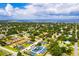 Aerial view of a neighborhood with a playground, trees, single Gathering and multi Gathering homes, and wide streets at 621 Rebecca Dr, St Cloud, FL 34769