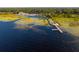 Scenic waterfront view featuring a pier, a gazebo, marshland vegetation, and calm water on a sunny day at 621 Rebecca Dr, St Cloud, FL 34769
