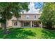Large backyard with a covered patio and lush green grass at 6957 Northwich Dr, Windermere, FL 34786