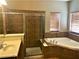 Bathroom showcasing a tiled shower, soaking tub, and vanity at 6957 Northwich Dr, Windermere, FL 34786