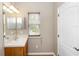 Well-lit bathroom with a mirror, vanity, and a window at 6957 Northwich Dr, Windermere, FL 34786