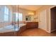 Bright bathroom featuring a tub, shower, wood cabinets, and large mirror at 6957 Northwich Dr, Windermere, FL 34786