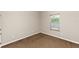 Neutral bedroom with large window and neutral carpet at 6957 Northwich Dr, Windermere, FL 34786