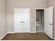 Neutral bedroom with double closet and open doorway at 6957 Northwich Dr, Windermere, FL 34786