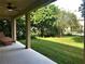 Covered patio showcases a comfortable outdoor space overlooking a well-maintained lawn at 6957 Northwich Dr, Windermere, FL 34786