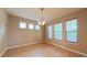 Bright dining room with wood floors, chandelier lighting, and three windows at 6957 Northwich Dr, Windermere, FL 34786