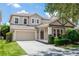Inviting two-story home featuring a neutral color palette, attached garage, and a well-maintained lawn and landscaping at 6957 Northwich Dr, Windermere, FL 34786