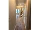 Inviting hallway with carpet and neutral tones leads to living spaces and staircase at 6957 Northwich Dr, Windermere, FL 34786