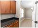 Hallway with hardwood floors, dark cabinets, granite counters, and view to office space at 6957 Northwich Dr, Windermere, FL 34786