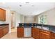 Open kitchen with breakfast bar featuring stainless steel dishwasher and double sink at 6957 Northwich Dr, Windermere, FL 34786