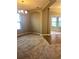 Open living room showcasing carpeted floors, arched entryway, and a chandelier at 6957 Northwich Dr, Windermere, FL 34786