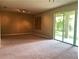 Spacious living room with carpet flooring, sliding glass door, and abundant natural light at 6957 Northwich Dr, Windermere, FL 34786