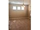 The living room has neutral walls, wall-to-wall carpeting, and a three-light chandelier at 6957 Northwich Dr, Windermere, FL 34786