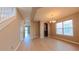 Open-concept living room with wood floors, chandelier lighting, and staircase at 6957 Northwich Dr, Windermere, FL 34786