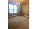 Spacious living area features neutral carpet, a large window with blinds, and an elegant chandelier at 6957 Northwich Dr, Windermere, FL 34786