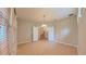 Open living room with wood floors and view of the staircase through white french doors at 6957 Northwich Dr, Windermere, FL 34786