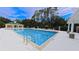 Relaxing pool area with lounge chairs and clubhouse, perfect for enjoying sunny days and community fun at 6957 Northwich Dr, Windermere, FL 34786