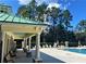 Community swimming pool featuring lounge seating, pergola and adjacent covered patio at 6957 Northwich Dr, Windermere, FL 34786
