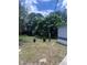 Expansive backyard with mature trees providing a private space for relaxing and entertainment at 710 Whispering Pines Dr, Auburndale, FL 33823
