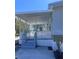 A covered porch with white lattice railings offers a charming outdoor relaxation spot at 710 Whispering Pines Dr, Auburndale, FL 33823
