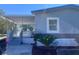 Charming single story home featuring a covered porch, complemented by fresh landscaping and healthy palm trees at 710 Whispering Pines Dr, Auburndale, FL 33823