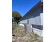 Side view of the house with updated siding and an efficient AC unit installed next to the home at 710 Whispering Pines Dr, Auburndale, FL 33823