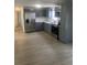 Modern kitchen featuring sleek gray cabinetry, stainless steel appliances, and light wood grain flooring at 710 Whispering Pines Dr, Auburndale, FL 33823