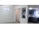 Open-concept living room and remodeled kitchen with gray cabinets at 710 Whispering Pines Dr, Auburndale, FL 33823